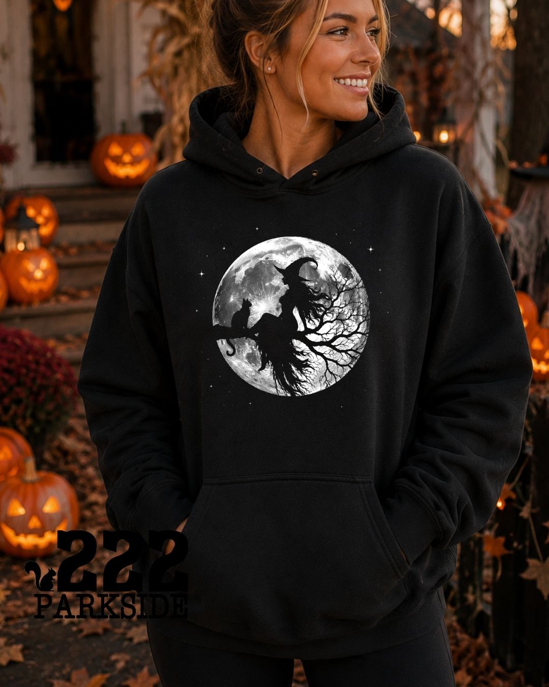 Midnight Ride witch and black cat full moon hoodie at a Halloween pumpkin display