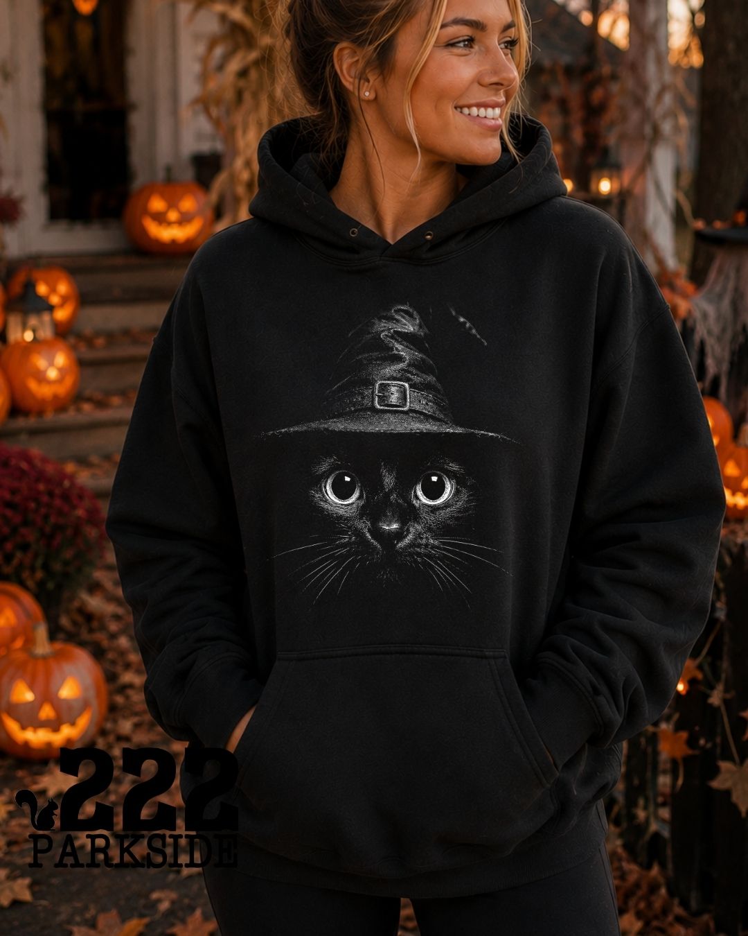 Witch hat black cat close-up hoodie at a Halloween pumpkin display