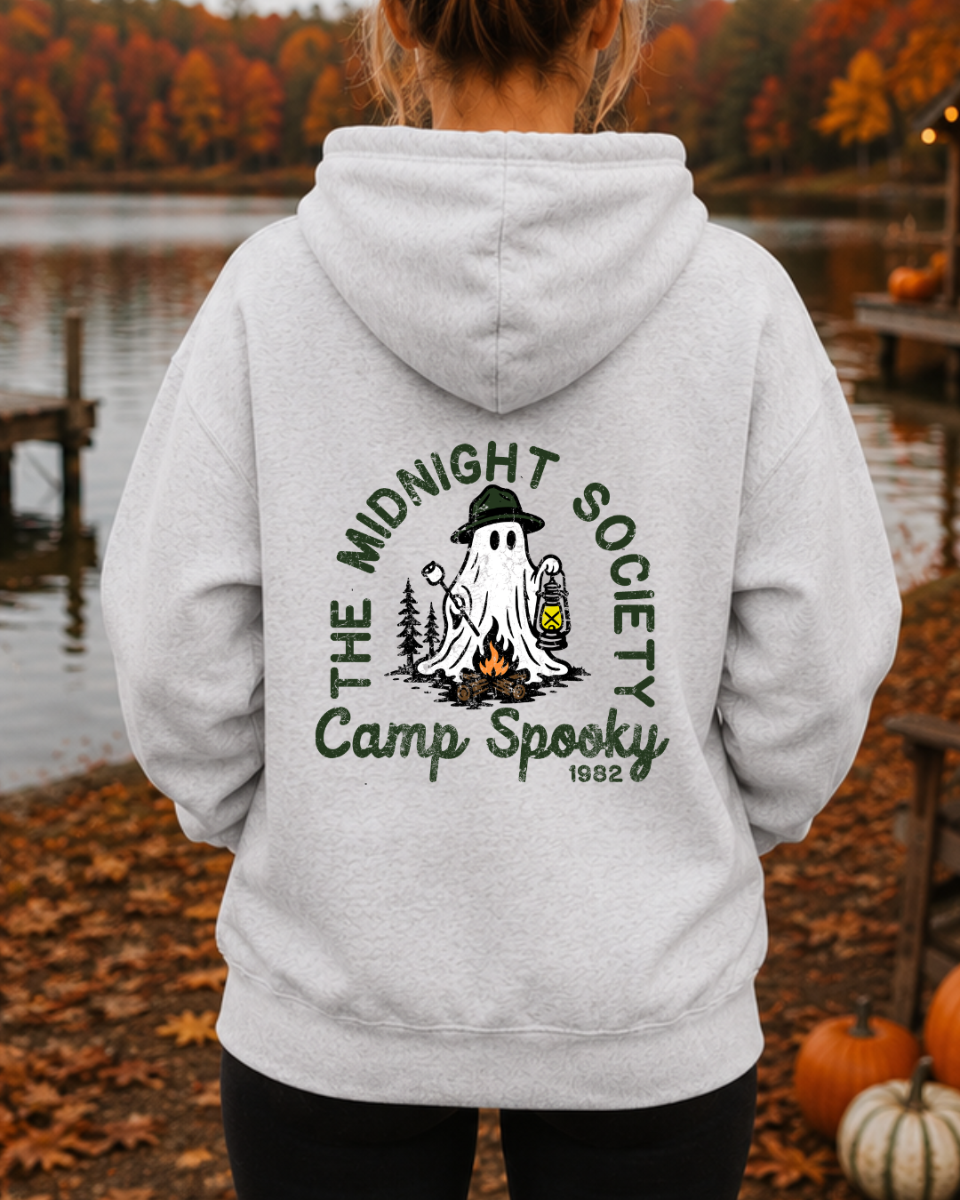 Front view of Camp Spooky Staff zip-up hoodie with badge chest graphic